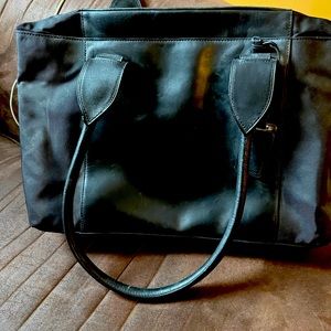 Tumi shoulder bag. Black. Practically new. Good for work, as a purse.